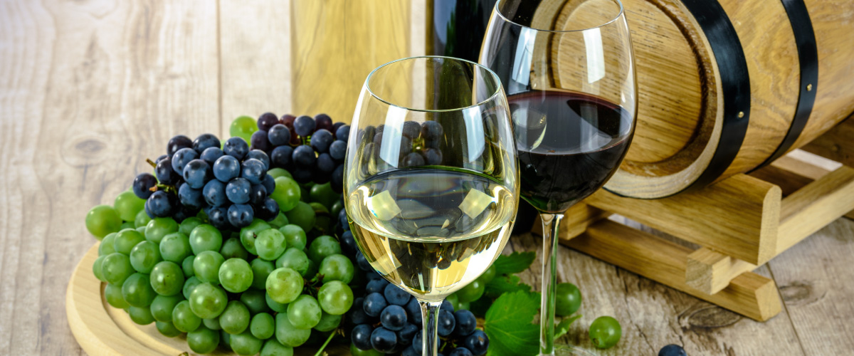 a glass of wine sitting on top of a table